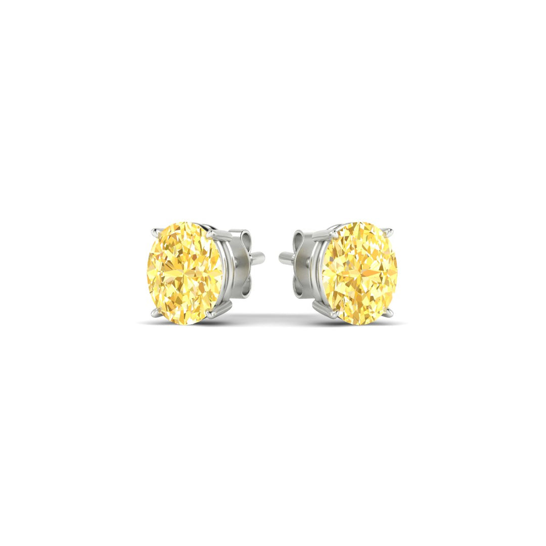 1-carat-oval-cut-vivid-yellow-diamond-stud-earrings-in-white-gold-fdear10411ovgvyellowangle3-1.00ct-nl-wg.jpg