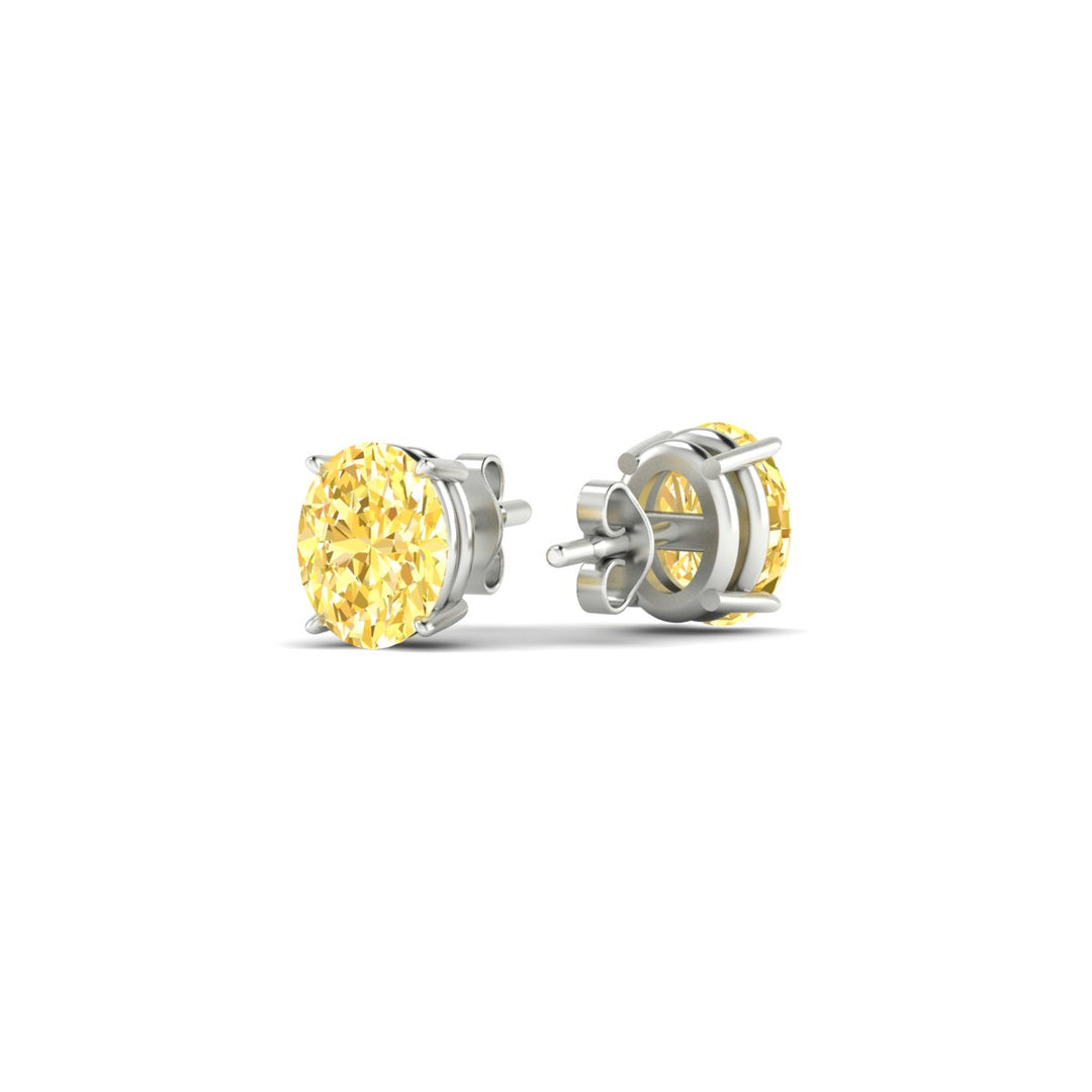 1-carat-oval-cut-vivid-yellow-diamond-stud-earrings-in-white-gold-fdear10411ovgvyellowangle4-1.00ct-nl-wg.jpg