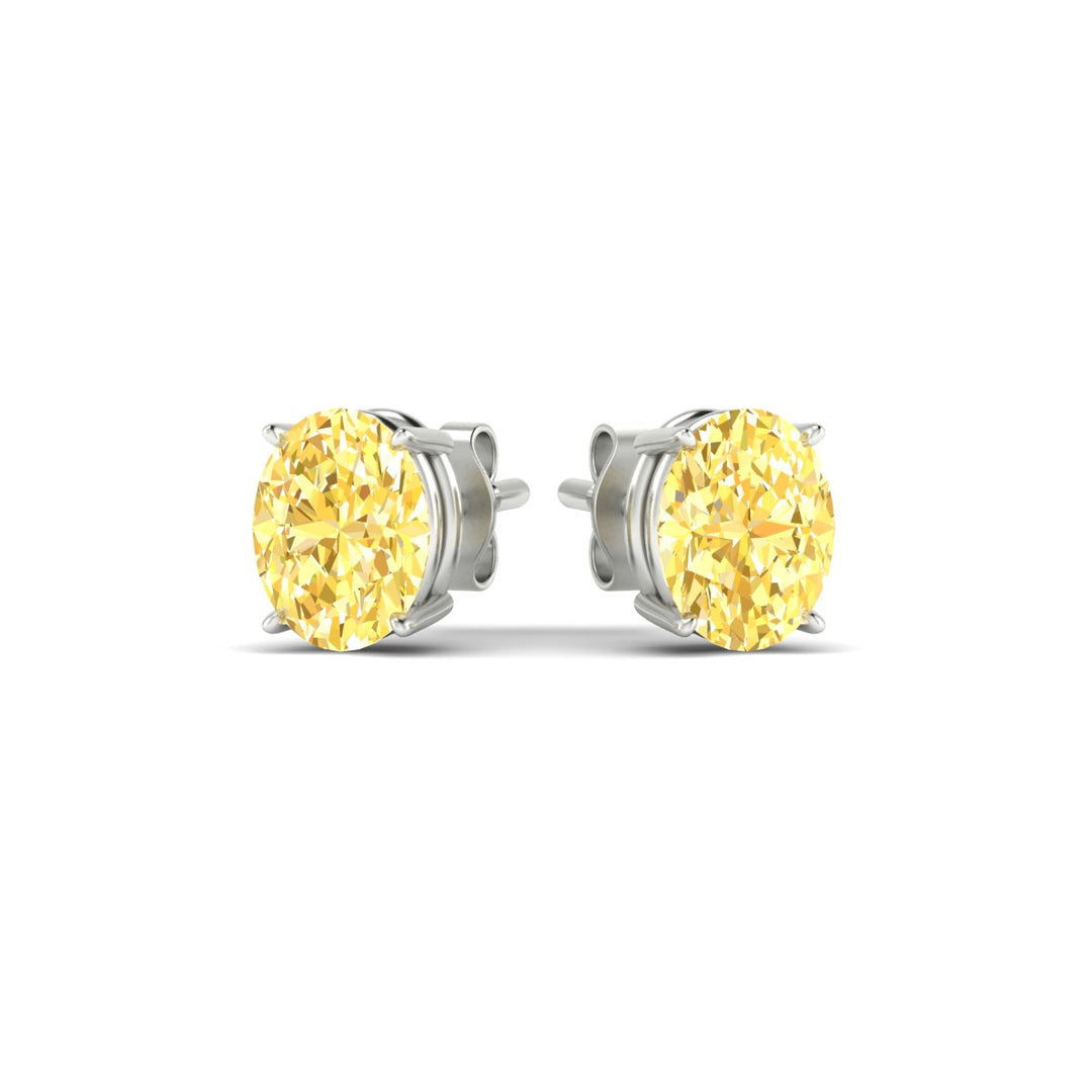 3-carat-oval-cut-vivid-yellow-diamond-stud-earrings-in-white-gold-fdear10411ovgvyellowangle3-3.00ct-nl-wg.jpg