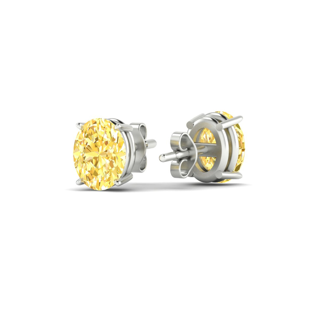 3-carat-oval-cut-vivid-yellow-diamond-stud-earrings-in-white-gold-fdear10411ovgvyellowangle4-3.00ct-nl-wg.jpg
