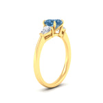 Load image into Gallery viewer, 3-stone-vivid-blue-cushion-cut-cathedral-ring-in-yellow-gold-fdenr9210cugvblueangle2-nl-yg.jpg