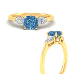 Load image into Gallery viewer, 3-stone-vivid-blue-cushion-cut-cathedral-ring-in-yellow-gold-fdenr9210cugvblueangle3-nl-yg.jpg