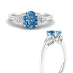 Load image into Gallery viewer, 3-stone-vivid-blue-oval-shaped-cathedral-ring-in-white-gold-fdenr9210ovgvblueangle3-nl-wg.jpg