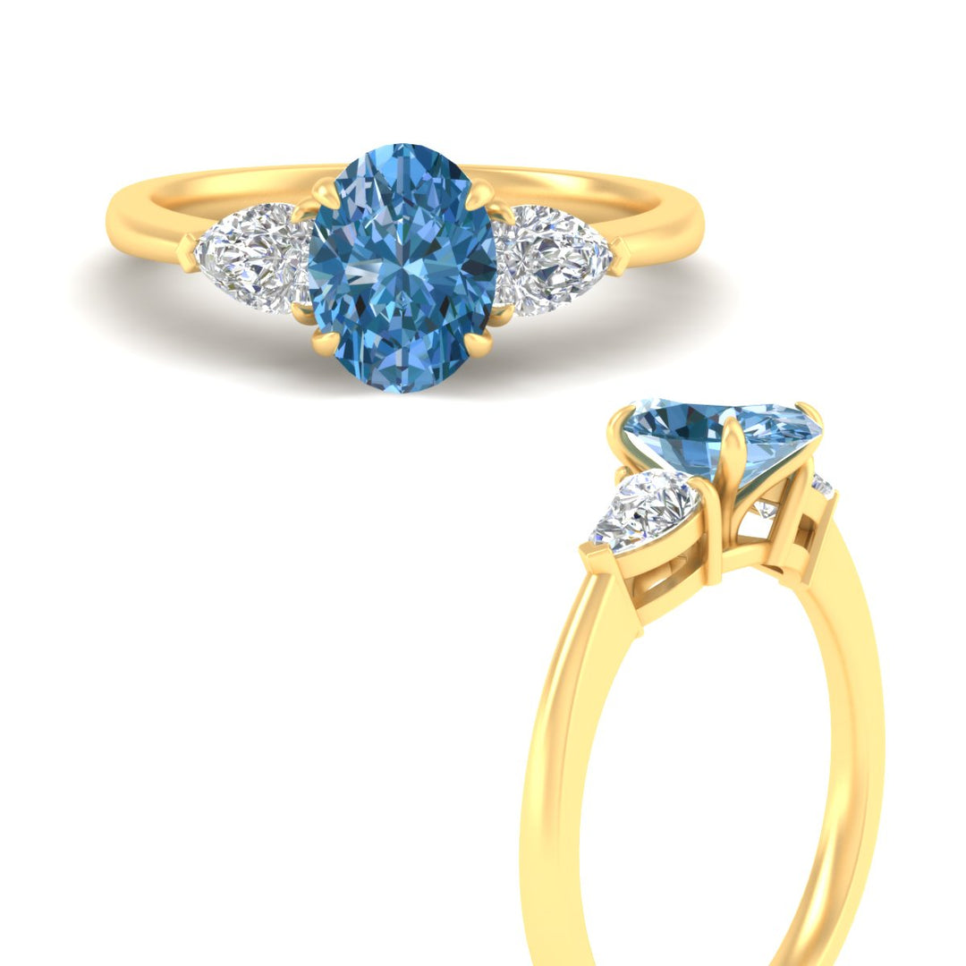 3-stone-vivid-blue-oval-shaped-cathedral-ring-in-yellow-gold-fdenr9210ovgvblueangle3-nl-yg.jpg