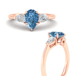 Load image into Gallery viewer, 3-stone-vivid-blue-pear-shaped-cathedral-ring-in-rose-gold-fdenr9210pegvblueangle3-nl-rg.jpg