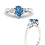 Load image into Gallery viewer, 3-stone-vivid-blue-pear-shaped-cathedral-ring-in-white-gold-fdenr9210pegvblueangle3-nl-wg.jpg