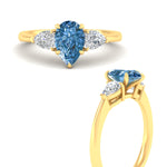 Load image into Gallery viewer, 3-stone-vivid-blue-pear-shaped-cathedral-ring-in-yellow-gold-fdenr9210pegvblueangle3-nl-yg.jpg