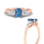 Load image into Gallery viewer, 3-stone-vivid-blue-radiant-cut-cathedral-ring-in-rose-gold-fdenr9210ragvblueangle3-nl-rg.jpg