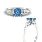 Load image into Gallery viewer, 3-stone-vivid-blue-radiant-cut-cathedral-ring-in-white-gold-fdenr9210ragvblueangle3-nl-wg.jpg
