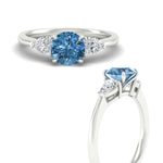 Load image into Gallery viewer, 3-stone-vivid-blue-round-cut-cathedral-ring-in-white-gold-fdenr9210rogvblueangle3-nl-wg.jpg