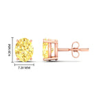 Load image into Gallery viewer, 4-carat-oval-cut-vivid-yellow-diamond-stud-earrings-in-rose-gold-fdear10411ovgvyellowangle2-4.00ct-nl-rg-hw.jpg