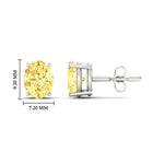 Load image into Gallery viewer, 4-carat-oval-cut-vivid-yellow-diamond-stud-earrings-in-white-gold-fdear10411ovgvyellowangle2-4.00ct-nl-wg-hw.jpg