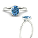 Load image into Gallery viewer, cushion-cut-collet-set-solitaire-vivid-blue-engagement-ring-in-white-gold-fdenr11593cugvblueangle3-nl-wg.jpg