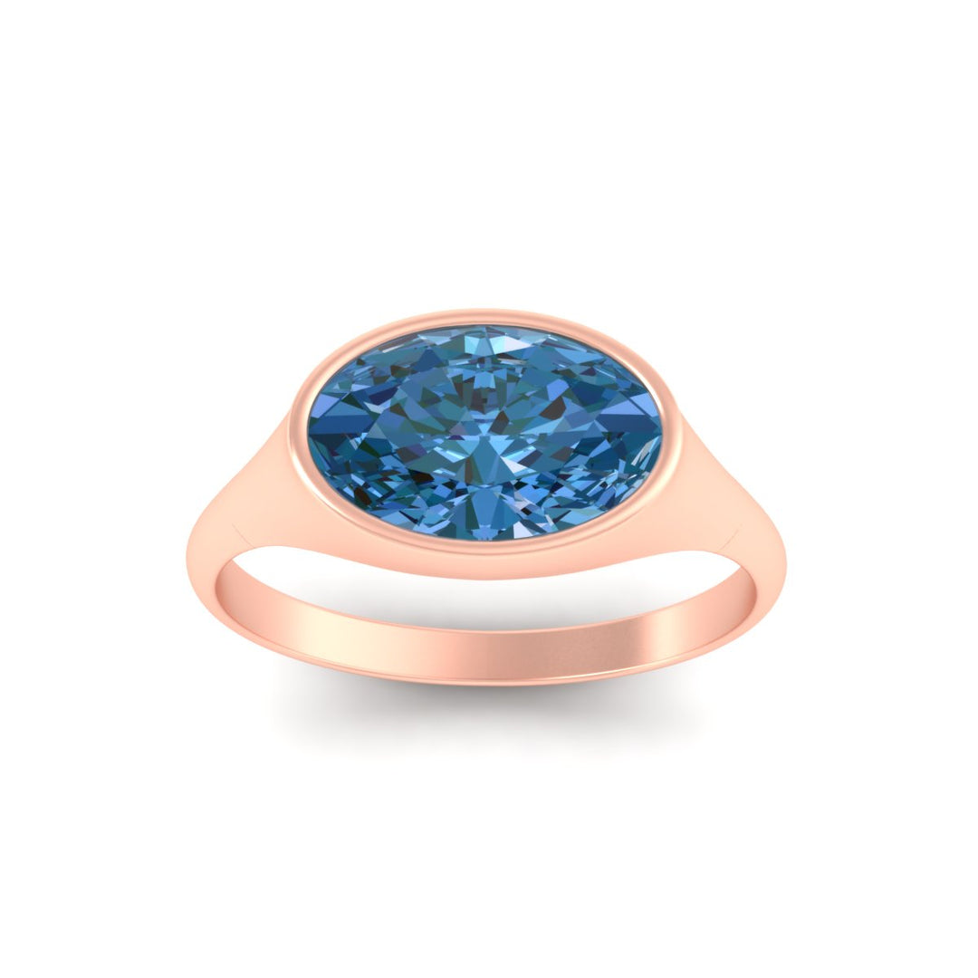 east-west-oval-bezel-vivid-blue-engagement-ring-in-rose-gold-fdenr11606gvblueangle5-nl-rg.jpg?v=1789038635