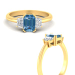 Load image into Gallery viewer, emerald-cut-vivid-blue-trapezoid-engagement-ring-in-yellow-gold-fdenr7981emgvblueangle3-nl-yg.jpg?v=1788347229