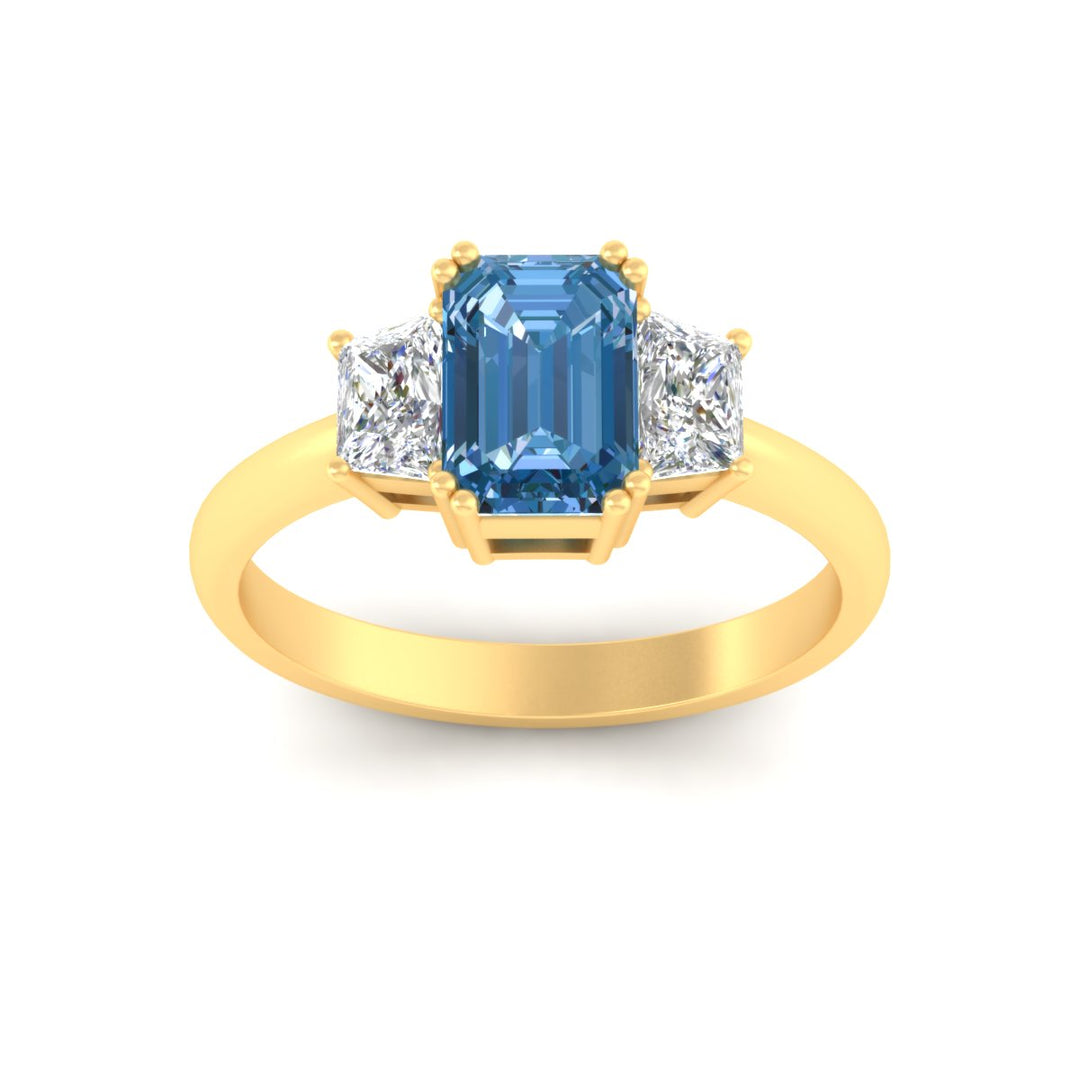 emerald-cut-vivid-blue-trapezoid-engagement-ring-in-yellow-gold-fdenr7981emgvblueangle5-nl-yg.jpg?v=1788347229