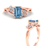 Load image into Gallery viewer, floral-leaf-emerald-cut-vivid-blue-engagement-ring-in-rose-gold-fdenr10962emgvblueangle3-nl-rg.jpg