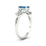 Load image into Gallery viewer, floral-leaf-emerald-cut-vivid-blue-engagement-ring-in-white-gold-fdenr10962emgvblueangle2-nl-wg.jpg
