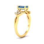 Load image into Gallery viewer, floral-leaf-emerald-cut-vivid-blue-engagement-ring-in-yellow-gold-fdenr10962emgvblueangle2-nl-yg.jpg