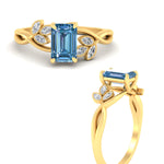 Load image into Gallery viewer, floral-leaf-emerald-cut-vivid-blue-engagement-ring-in-yellow-gold-fdenr10962emgvblueangle3-nl-yg.jpg