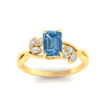 Load image into Gallery viewer, floral-leaf-emerald-cut-vivid-blue-engagement-ring-in-yellow-gold-fdenr10962emgvblueangle5-nl-yg.jpg