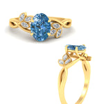 Load image into Gallery viewer, floral-leaf-oval-shaped-vivid-blue-engagement-ring-in-yellow-gold-fdenr10962ovgvblueangle3-nl-yg.jpg