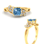 Load image into Gallery viewer, floral-leaf-princess-cut-vivid-blue-engagement-ring-in-yellow-gold-fdenr10962prgvblueangle3-nl-yg.jpg