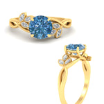 Load image into Gallery viewer, floral-leaf-round-cut-vivid-blue-engagement-ring-in-yellow-gold-fdenr10962rogvblueangle3-nl-yg.jpg