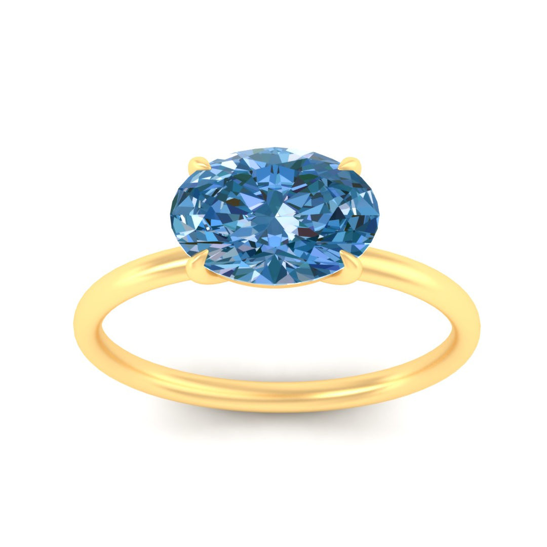 horizontal-oval-4-prong-vivid-blue-engagement-ring-in-yellow-gold-fd11749ovrgvblueangle5-nl-yg.jpg?v=1788845172