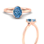 Load image into Gallery viewer, oval-shaped-collet-set-solitaire-vivid-blue-engagement-ring-in-rose-gold-fdenr11593ovgvblueangle3-nl-rg.jpg