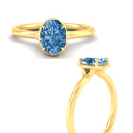 Load image into Gallery viewer, oval-shaped-collet-set-solitaire-vivid-blue-engagement-ring-in-yellow-gold-fdenr11593ovgvblueangle3-nl-yg.jpg
