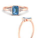 Load image into Gallery viewer, petite-bezel-set-emerald-cut-vivid-blue-engagement-ring-in-rose-gold-fdenr9175emgvblueangle3-nl-rg.jpg