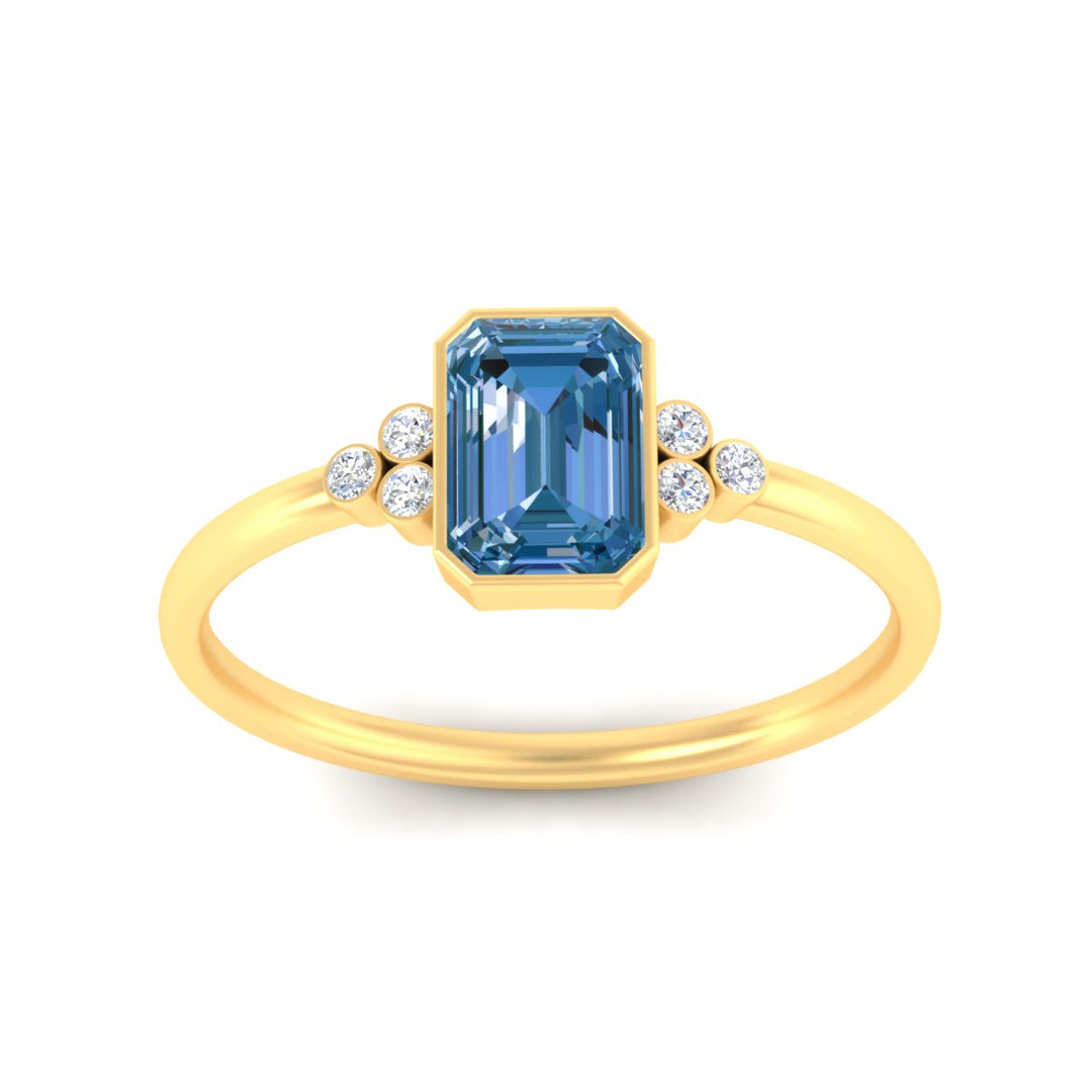 petite-bezel-set-emerald-cut-vivid-blue-engagement-ring-in-yellow-gold-fdenr9175emgvblueangle5-nl-yg.jpg