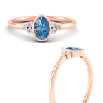Load image into Gallery viewer, petite-bezel-set-oval-shaped-vivid-blue-engagement-ring-in-rose-gold-fdenr9175ovgvblueangle3-nl-rg.jpg