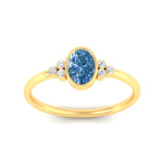 Load image into Gallery viewer, petite-bezel-set-oval-shaped-vivid-blue-engagement-ring-in-yellow-gold-fdenr9175ovgvblueangle5-nl-yg.jpg