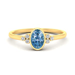 Load image into Gallery viewer, petite-bezel-set-oval-shaped-vivid-blue-engagement-ring-in-yellow-gold-fdenr9175ovgvbluesleep-nl-yg.jpg