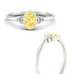 Load image into Gallery viewer, petite-bezel-set-oval-shaped-vivid-yellow-engagement-ring-in-white-gold-fdenr9175ovgvyellowangle3-nl-wg.jpg