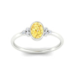 Load image into Gallery viewer, petite-bezel-set-oval-shaped-vivid-yellow-engagement-ring-in-white-gold-fdenr9175ovgvyellowangle5-nl-wg.jpg