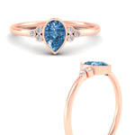 Load image into Gallery viewer, petite-bezel-set-pear-shaped-vivid-blue-engagement-ring-in-rose-gold-fdenr9175pegvblueangle3-nl-rg.jpg