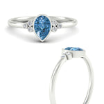 Load image into Gallery viewer, petite-bezel-set-pear-shaped-vivid-blue-engagement-ring-in-white-gold-fdenr9175pegvblueangle3-nl-wg.jpg