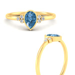 Load image into Gallery viewer, petite-bezel-set-pear-shaped-vivid-blue-engagement-ring-in-yellow-gold-fdenr9175pegvblueangle3-nl-yg.jpg