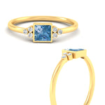 Load image into Gallery viewer, petite-bezel-set-princess-cut-vivid-blue-engagement-ring-in-yellow-gold-fdenr9175prgvblueangle3-nl-yg.jpg