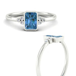 Load image into Gallery viewer, petite-bezel-set-radiant-cut-vivid-blue-engagement-ring-in-white-gold-fdenr9175ragvblueangle3-nl-wg.jpg