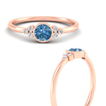 Load image into Gallery viewer, petite-bezel-set-round-cut-vivid-blue-engagement-ring-in-rose-gold-fdenr9175rogvblueangle3-nl-rg.jpg