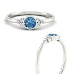 Load image into Gallery viewer, petite-bezel-set-round-cut-vivid-blue-engagement-ring-in-white-gold-fdenr9175rogvblueangle3-nl-wg.jpg