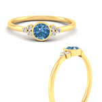 Load image into Gallery viewer, petite-bezel-set-round-cut-vivid-blue-engagement-ring-in-yellow-gold-fdenr9175rogvblueangle3-nl-yg.jpg