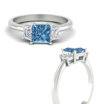 Load image into Gallery viewer, princess-cut-vivid-blue-trapezoid-engagement-ring-in-white-gold-fdenr7981prgvblueangle3-nl-wg.jpg