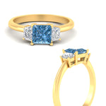 Load image into Gallery viewer, princess-cut-vivid-blue-trapezoid-engagement-ring-in-yellow-gold-fdenr7981prgvblueangle3-nl-yg.jpg