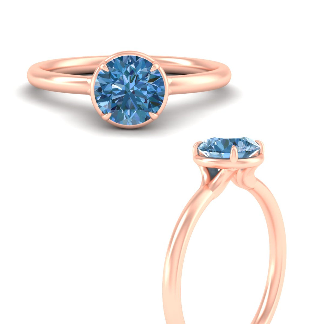 round-cut-collet-set-solitaire-vivid-blue-engagement-ring-in-rose-gold-fdenr11593rogvblueangle3-nl-rg.jpg