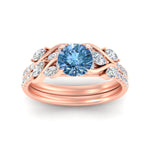 Load image into Gallery viewer, https://cdn.fascinatingdiamonds.com/fdens11635/round-cut-curved-vine-vivid-blue-wedding-ring-set-in-rose-gold-fdens11635gvblueangle-nl-rg.jpg